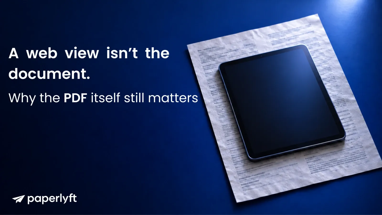 A tablet with a blank screen lying on a larger printed document on a dark navy background.